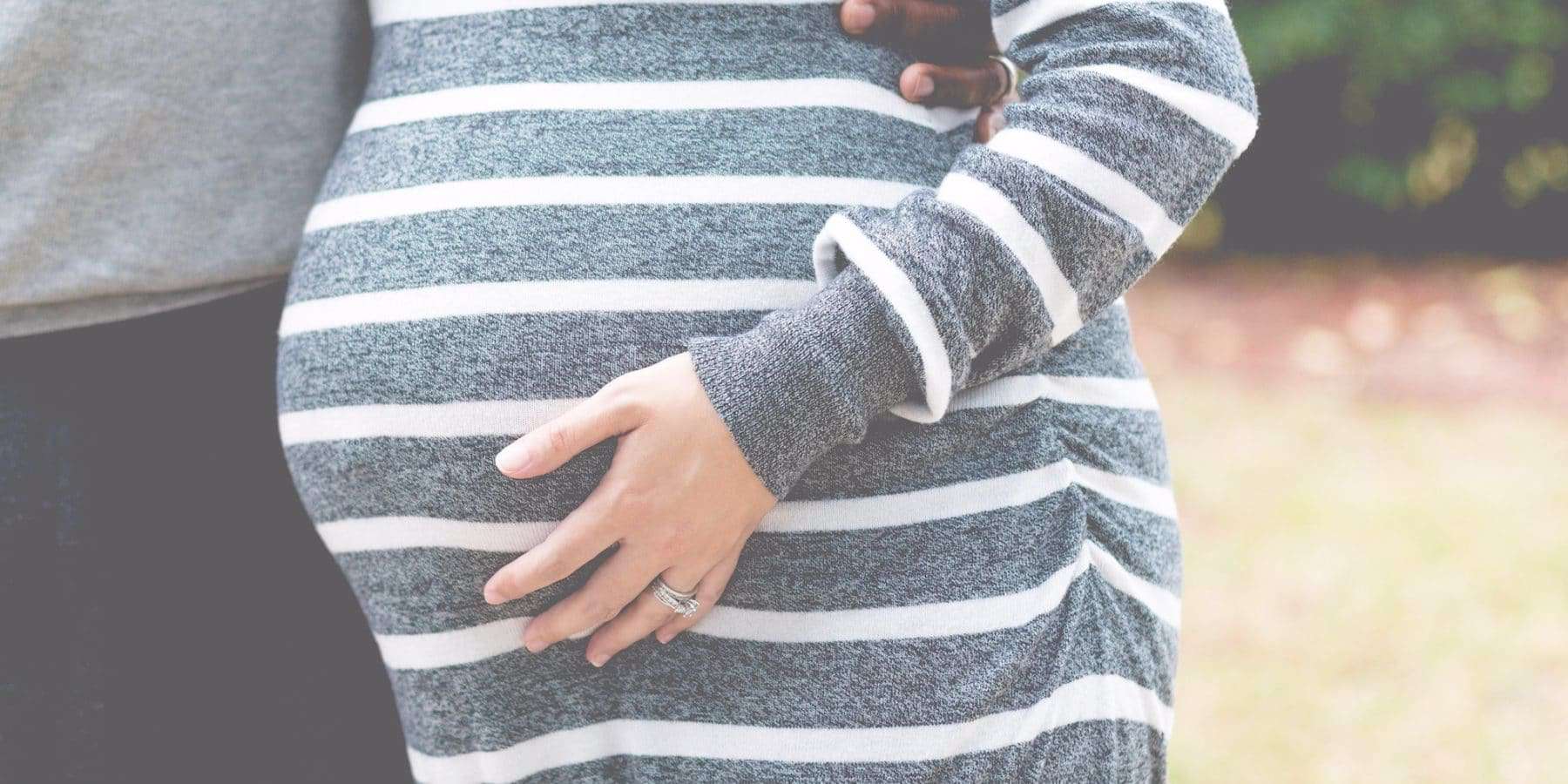 image of pregnant woman with hand on belly