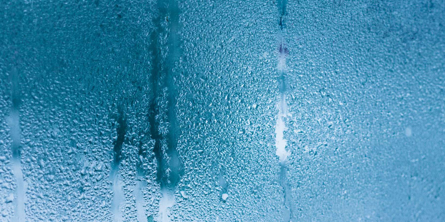 Window covered in condensation from high home humidity levels.